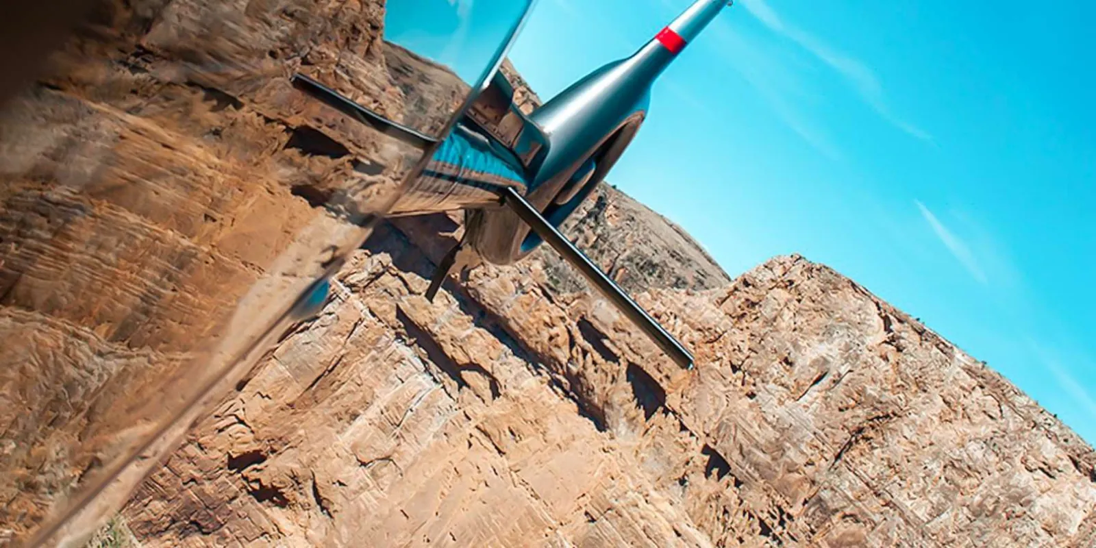 Low-angle view of the ECO-Star against a sandstone wall and clear blue sky