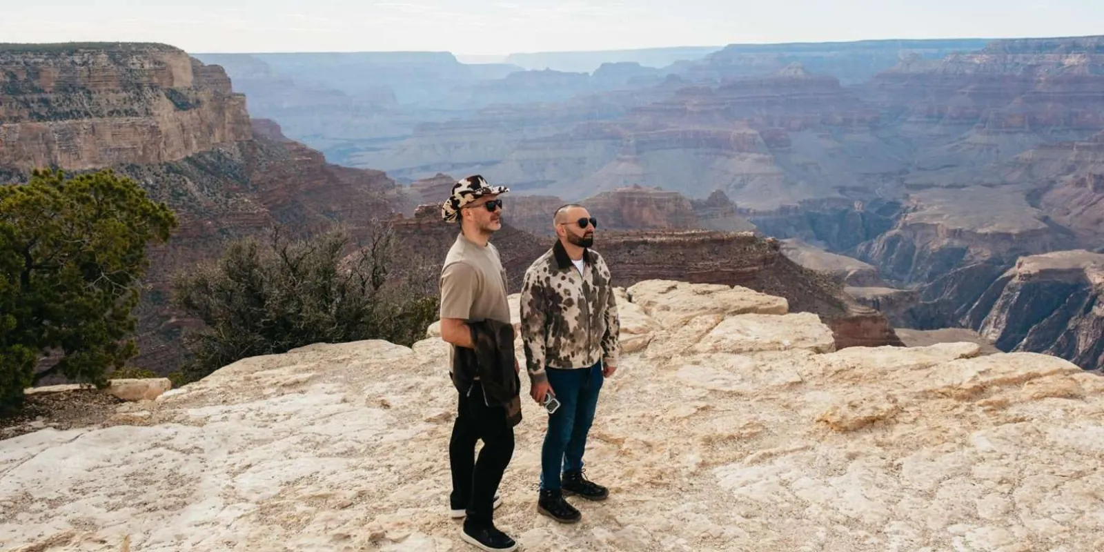 Two travellers at a South Rim viewpoint above the inner gorge