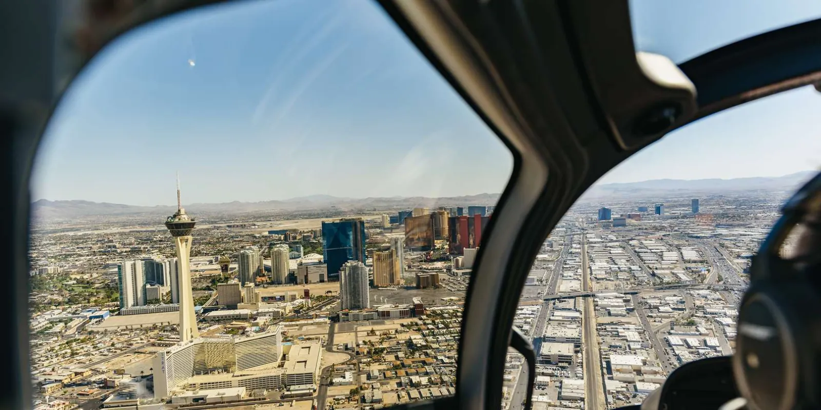 The Las Vegas Strip skyline framed through a helicopter window on the return flight