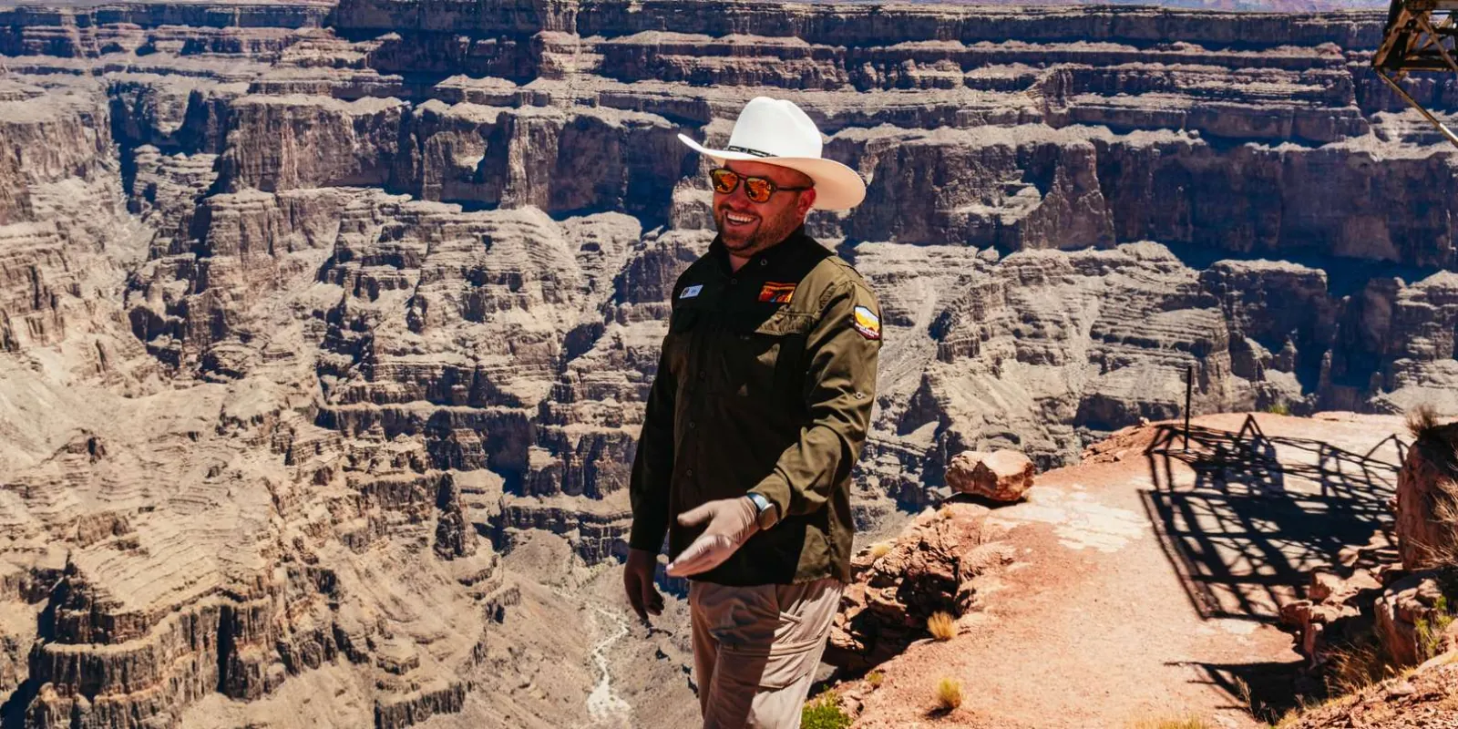 Hualapai guide talking to guests at the edge of the Grand Canyon West rim